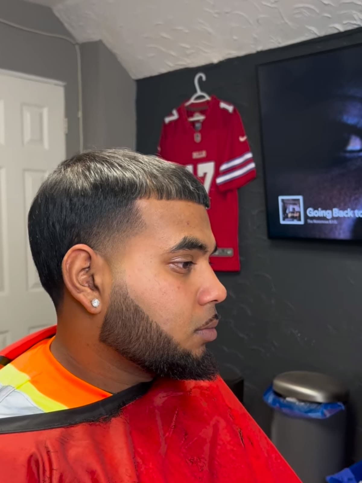 Low taper fade with a textured silver top and a sharp line-up